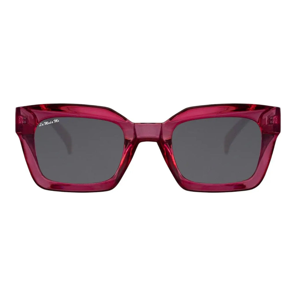 Luum sustainable sunglasses with translucent red acetate chunky square frames and dark grey lenses.